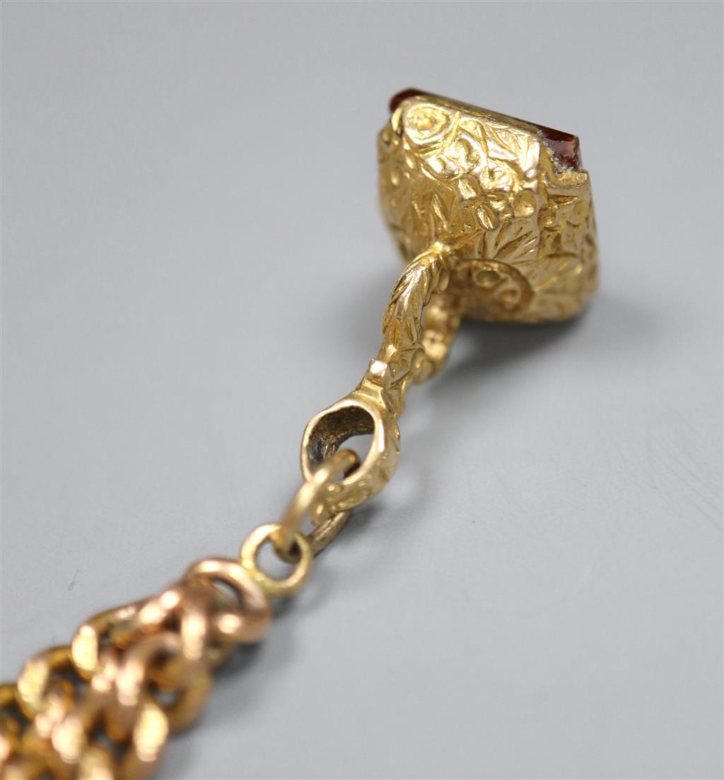 An early 20th century 9ct gold curblink bracelet, hung with a yellow metal overlaid carnelian set fob seal,